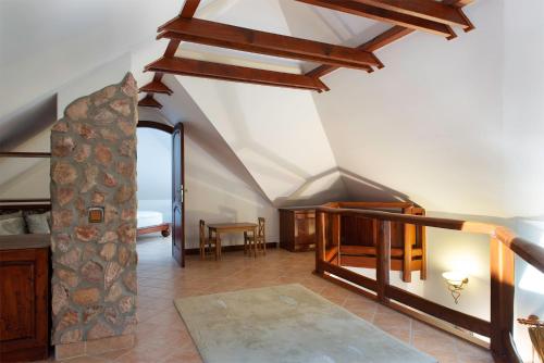 an attic room with a staircase and a bedroom at Hajdu Apartman 2. in Hajdúszoboszló