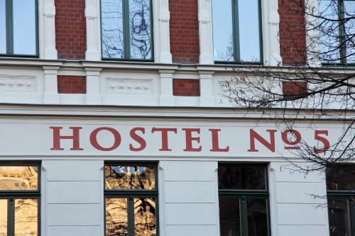 a building with a sign on the front of it at Hostel No 5 in Halle an der Saale