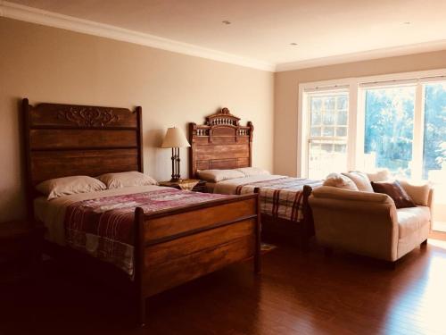 a bedroom with two beds and a couch and a window at Seaview White House in Stratford