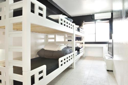
two bunk beds in a small room at Khaosan Tokyo Laboratory in Tokyo
