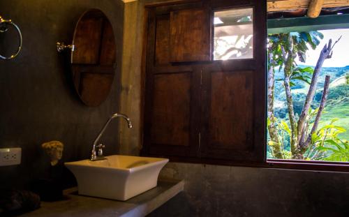 baño con lavabo y ventana en Casa El Cedro, en Charalá