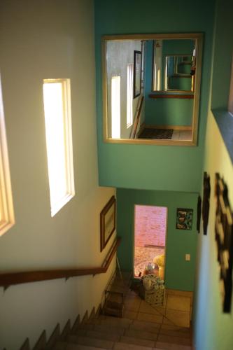 a view of a hallway with a mirror and stairs at Trojan House in Ensenada