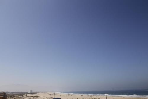 a view of a beach with the ocean in the background at Trojan House in Ensenada