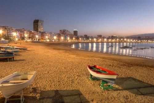 a group of boats on a beach at night at Hotel Verol in Las Palmas de Gran Canaria
