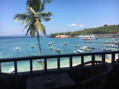 a view of a beach with boats in the water at Padangbai Beach inn in Padangbai