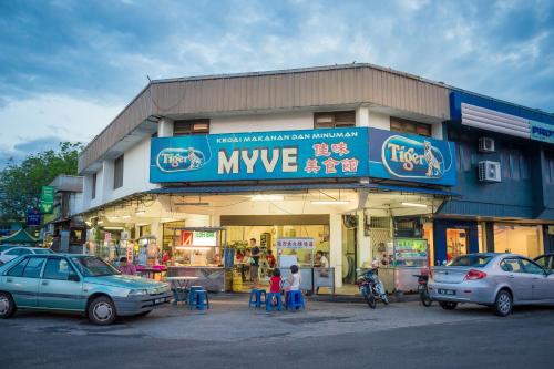 a large building with cars parked in front of it at Park Avenue Hotel Sungai Petani in Sungai Petani