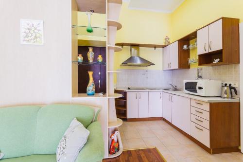 a kitchen with a couch and a microwave at Kiev Centre Apartments in Kyiv