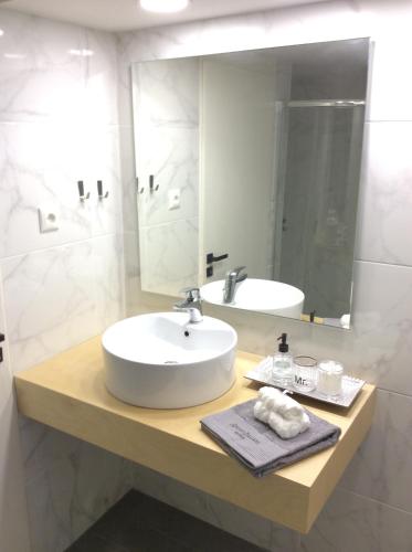 a bathroom with a sink and a mirror at Heraklion City Center Apartment in Heraklio