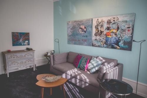 a living room with a couch and a table at Hotel Mon Repos in Geneva