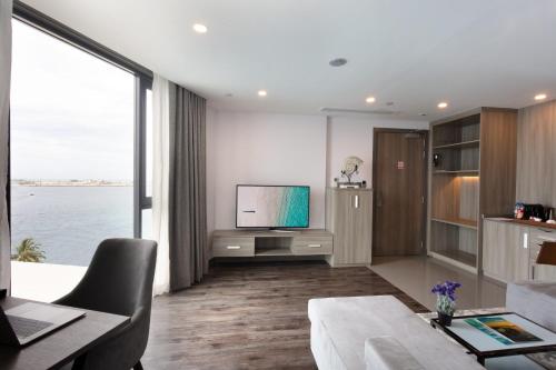 a living room with a tv and a large window at Maagiri Hotel in Male City