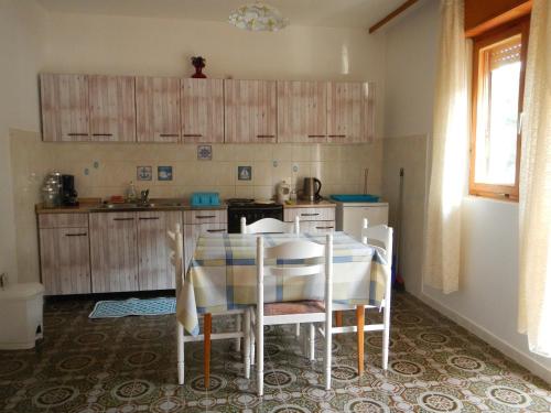 a kitchen with a table and chairs in a room at Dinka's Apartment in Stari Grad