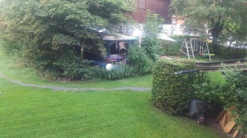 an image of a garden with a gazebo at Appartement Pension Bäckenhäusl FERIENWOHNUNGEN Chalets Hütten Komfortzimmer in Uttendorf