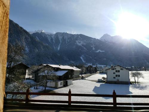 a view of a village with a snow covered mountain at Landhaus Eberler in Mayrhofen