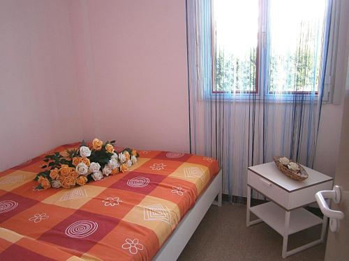 a bedroom with a bed with a flower arrangement on it at Biloba in Bibione