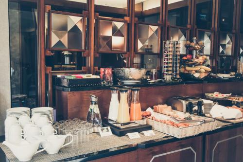 a kitchen with a counter with plates and utensils at Hotel Mon Repos in Geneva