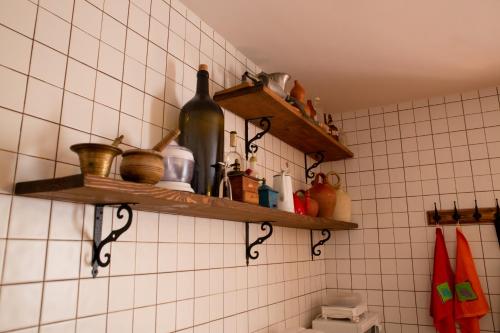 a bathroom with wooden shelves on the wall at Casa Magüeto in Combarros