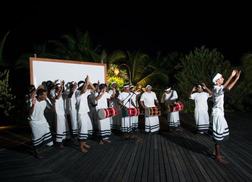 un groupe de personnes devant une représentation dans l'établissement Coco Palm Dhuni Kolhu, à Thulhaadhoo