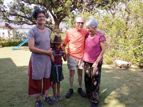 a family posing for a picture in a park at Oxygen Homestay-A Blissful Retreat in Dehradun