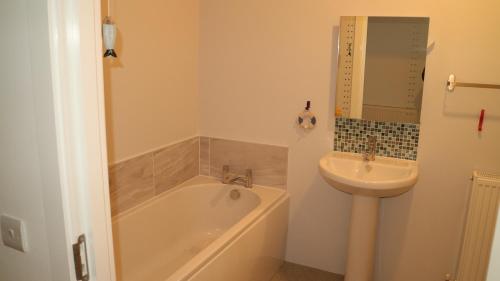 a bathroom with a bath tub and a sink at The Old Legion in Eyemouth
