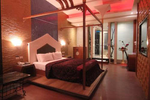a bedroom with a bed with a canopy at Romantic Code Art Motel in Shanhua