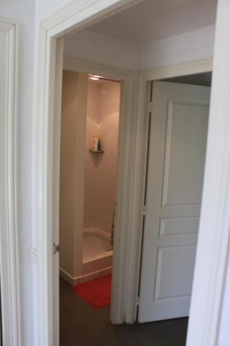 a door leading to a bathroom with a tub at Saint Denac - Golf de la Baule in Saint-André-des-Eaux