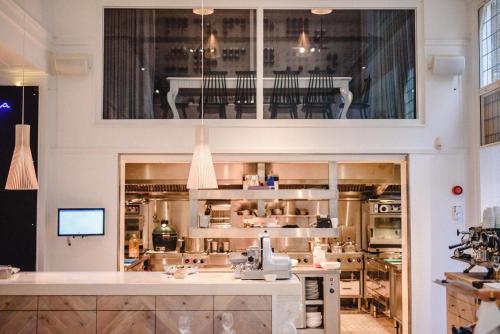a kitchen with a counter in a room at Hotel Manna in Nijmegen
