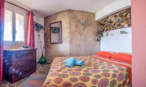 a bedroom with a bed with a blue stuffed animal on it at Appartamento Monica in Pantelleria