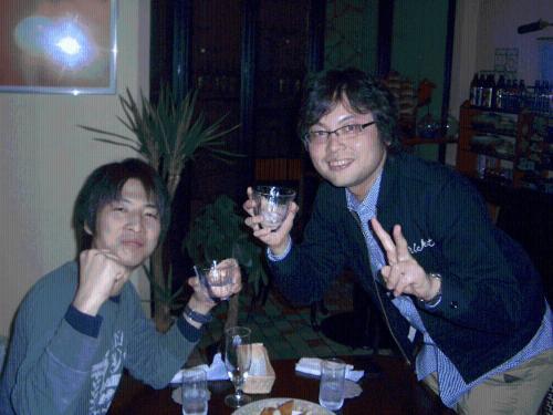 two men sitting at a table with wine glasses at Family Ryokan Kawakyu with Showa Retro, private hot spring in Ibusuki