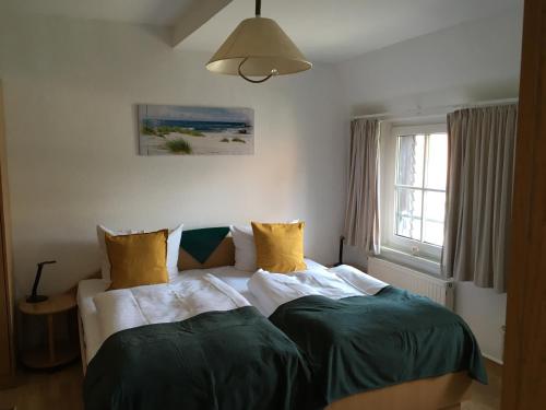 a bedroom with two beds and a window at Hotel-Pension Seeadler in Prerow