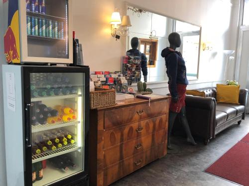 two people standing in a living room with a refrigerator at Urban Stay Salzburg City in Salzburg