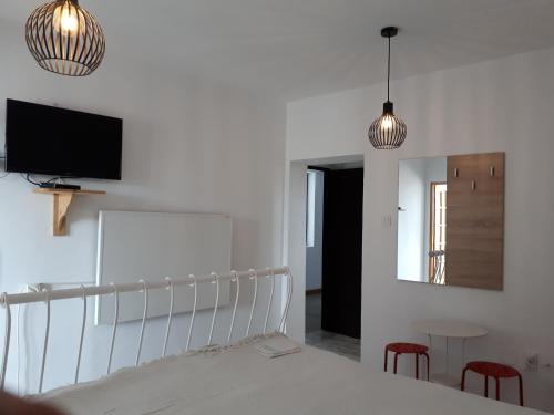 a bedroom with a bed and two red chairs at Motel Traffic in Linteşti