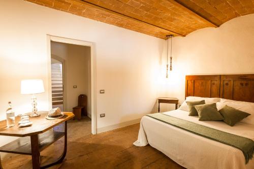 a bedroom with a bed and a table with a lamp at Tenuta Santa Trice in Riotorto