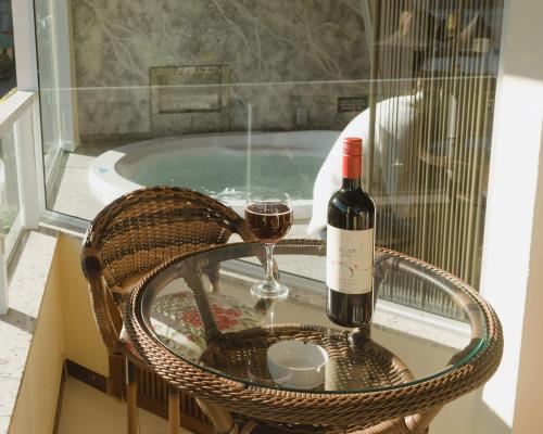 a bottle of wine and a glass of red wine at Pousada Ilha da Magia in Florianópolis