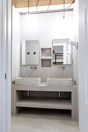 a bathroom with two sinks and a mirror at BORGOBELTRANI in Trani