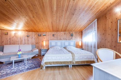 a bedroom with a bed and a couch at House Marija in Vilnius