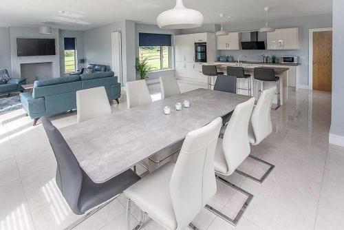 a dining room and kitchen with a table and chairs at Greenway Holiday Home in Dungarvan