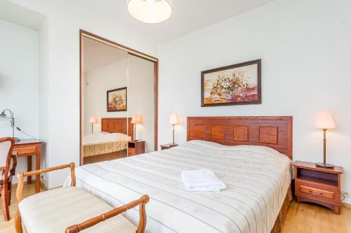 a bedroom with a large bed and a mirror at House Marija in Vilnius