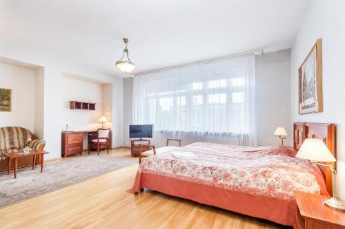 a bedroom with a large bed and a window at House Marija in Vilnius