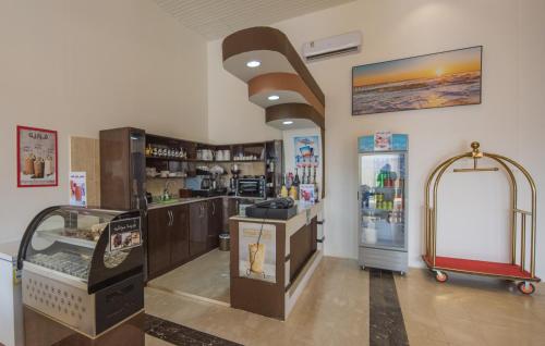 a grocery store with a cash register and a refrigerator at Tabalah ApartHotel in Al Bazaza