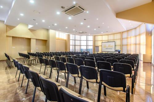 a conference room with chairs and a screen at Hotel La Mar in Kielce