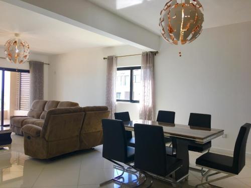 a living room with a table and a couch at Ocean view in Flic-en-Flac