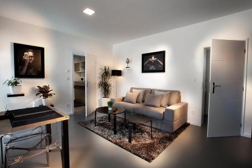 a living room with a couch and a table at Apartmány Ladná in Ladná