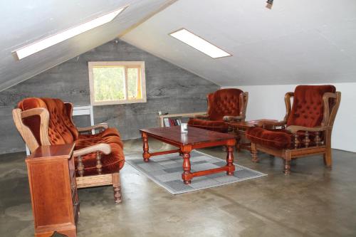 
a living room filled with furniture and a fire place at Lækjarhus Farm Holidays in Borgarhöfn
