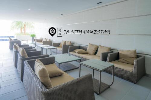 a row of chairs and tables in a waiting room at Pangsapuri Meridian by RR JBcity in Nusajaya