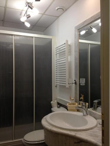 a bathroom with a sink and a toilet at Aksai Residence in Aksay