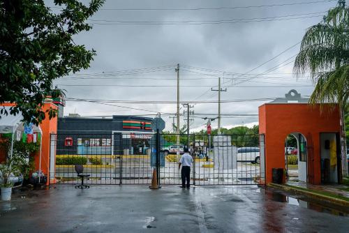 a man standing in front of a fence at Casa Aurora in Cancún