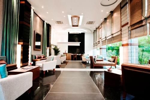 a lobby with couches and chairs and a table at Melange Astris in Bengaluru