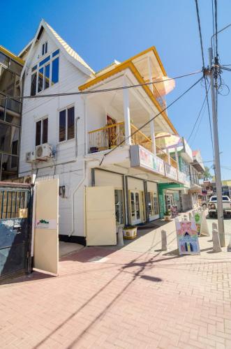 a white building with two refrigerators on a street at Pleasant Stay Paramaribo in Paramaribo
