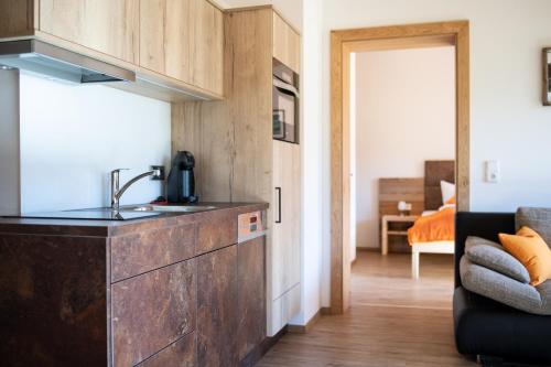 a kitchen with a sink and a couch in a room at Binter Apartments in Virgen