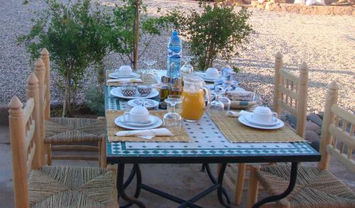 a table with a blue and white table cloth on it at Dar Bilal in Aït Ben Haddou